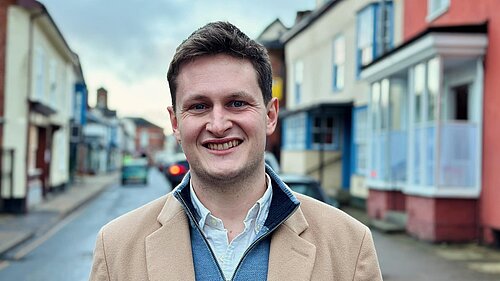 Headshot of David Chadwick standing on a local high street