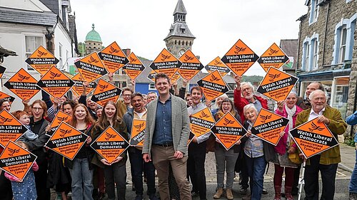 David Chadwick surrounded by supporters holding Lib Dem Diamonds